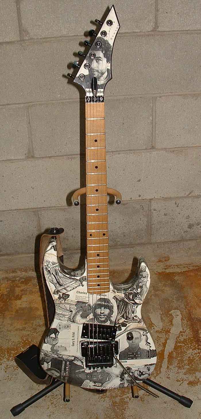 B.C. Rich Gunslinger 6 string electric guitar decoupaged with serial killer and Gray's Anatomy motif. Seymour Duncan Invader Humbucker pickup and Floyd Rose licensed locking tremelo.